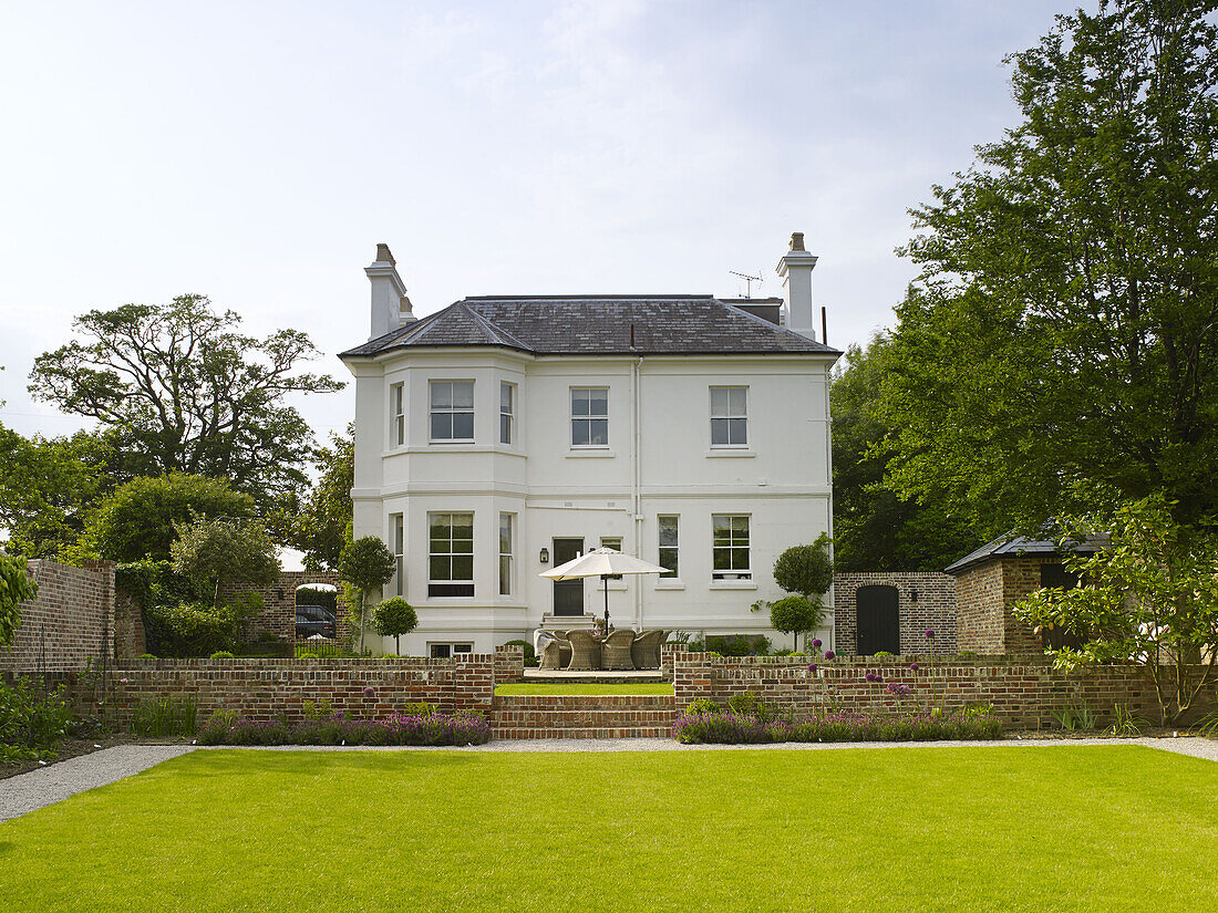 White detached east Sussex home set in lawned grounds England UK