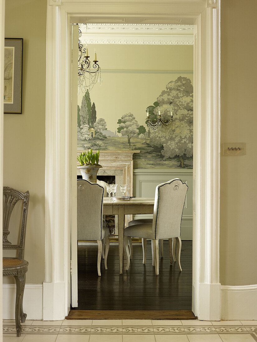 View through doorway to dining table in East Sussex country house England UK