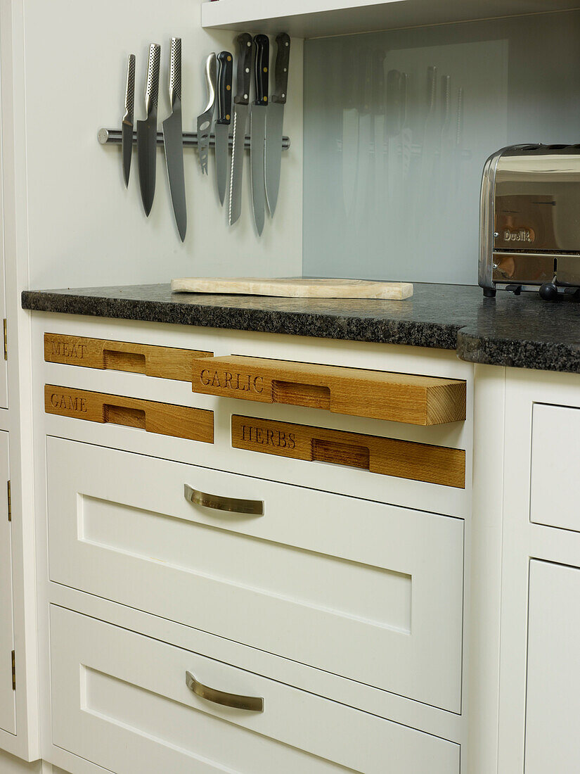 Magnetic knife strip with chopping board storage in Nottinghamshire kitchen England UK