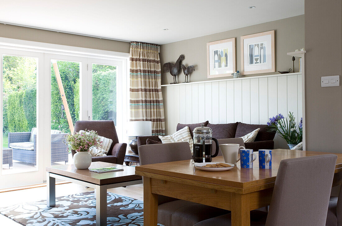 Dining table and chairs in open plan living room of Cambridgeshire home UK