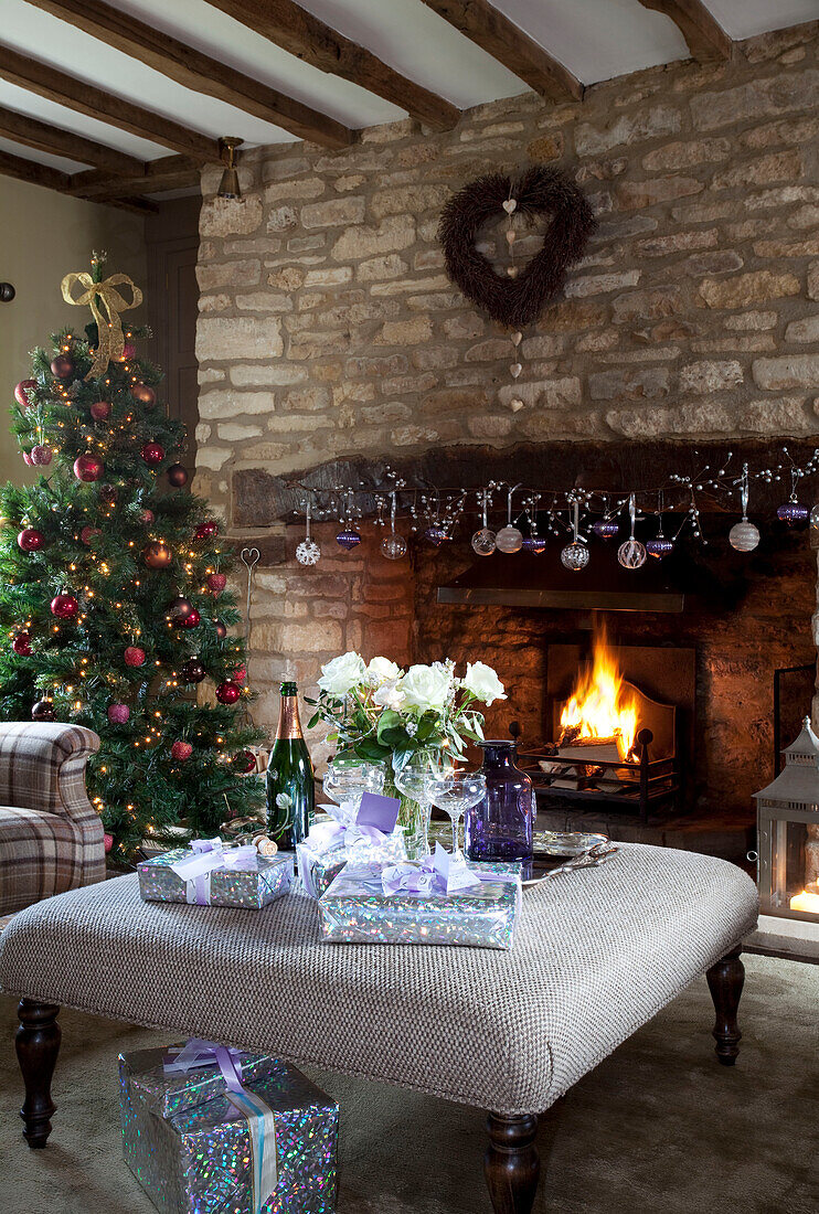 Champagne glasses and gifts at hearth of Cotswolds home UK