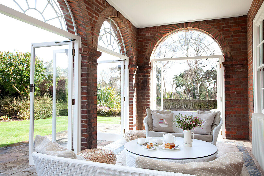 Arched brickwork doorways in garden room of Suffolk home UK