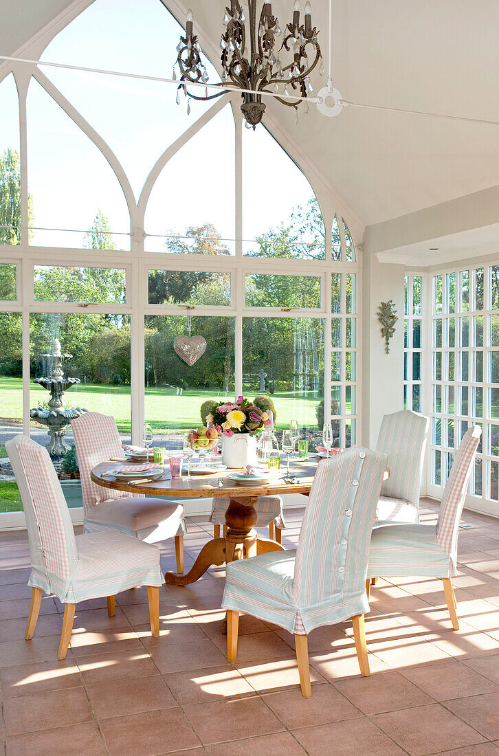 Table for six in high roofed conservatory of classic Berkshire home, England, UK