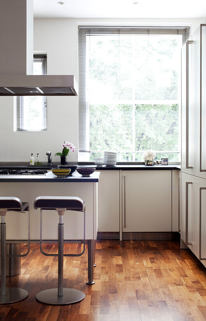 Bar stools in London kitchen with louvered blind UK