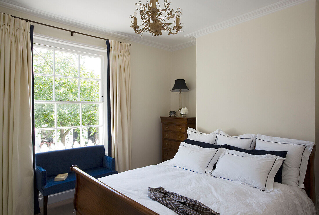 Sofa at window of townhouse bedroom