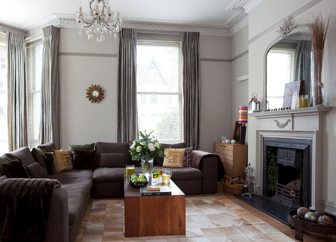 Corner sofa with wooden coffee table in contemporary living room, Hove, East Sussex, England, UK