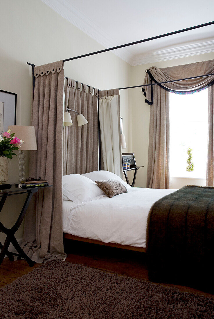 Fabric surround on four postered bed in classic bedroom of Tyne & Wear home, England, UK