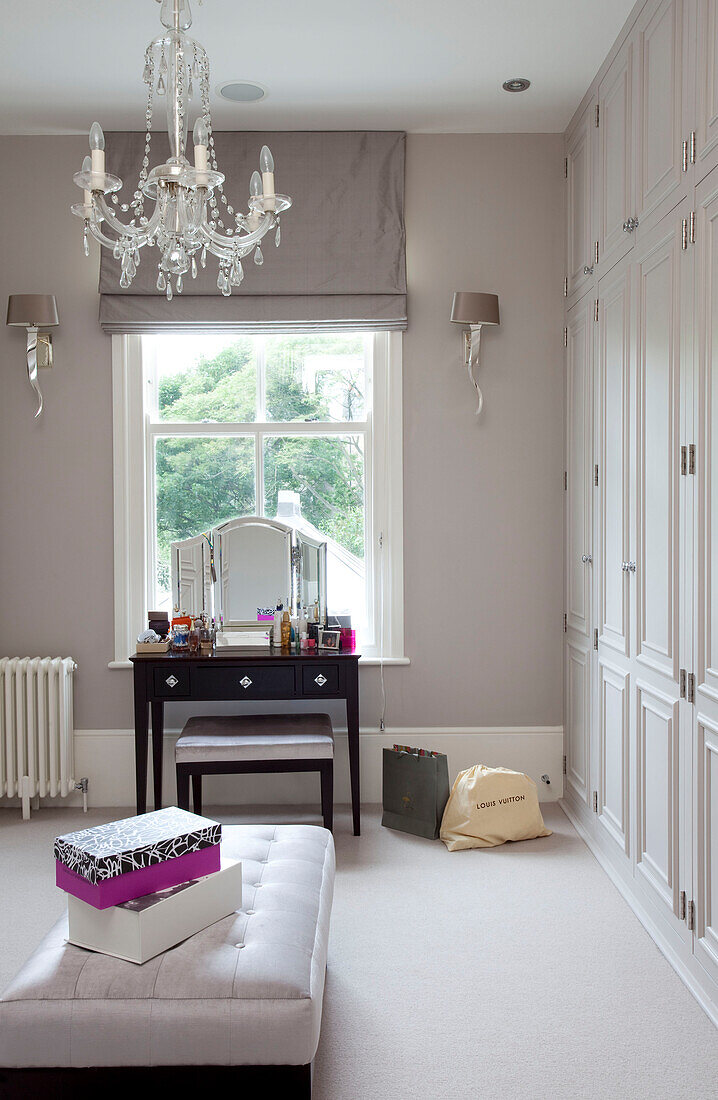 Table and mirror at dressing room window of classic London home, UK