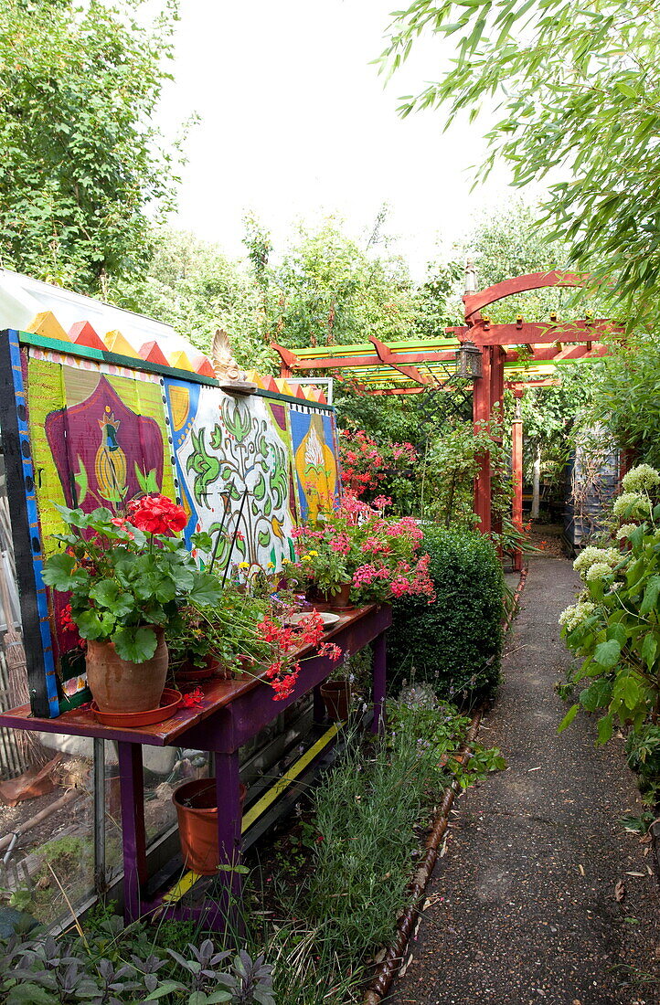 Handpainted artwork and pergola in garden of London home England UK