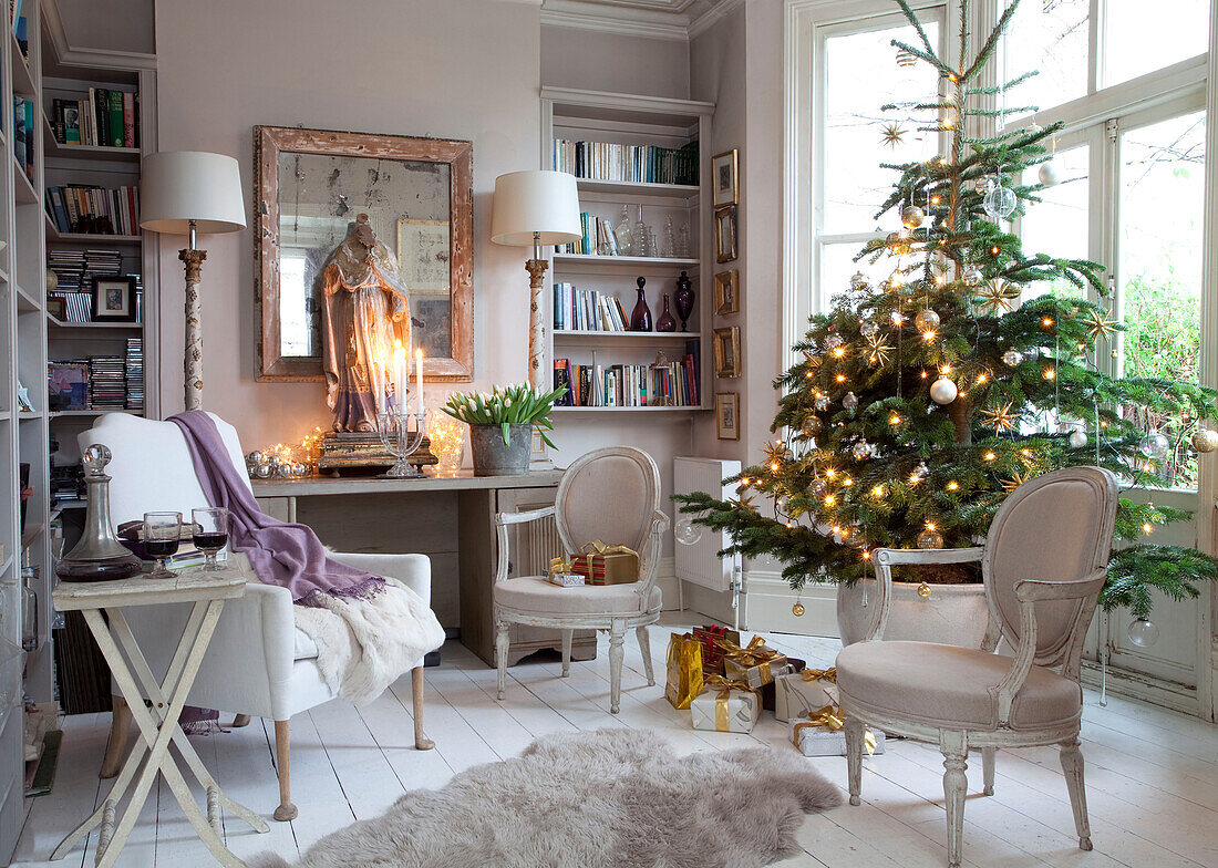 Christmas tree in bay window of London home with effigy on table, England, UK