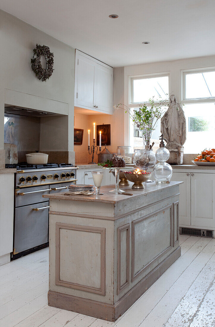 Christmas decorations and large statue in kitchen of London townhouse, England, UK