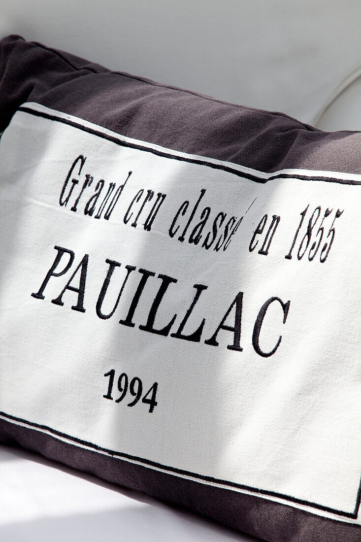 French text on cushion in contemporary Kent cottage, England, UK