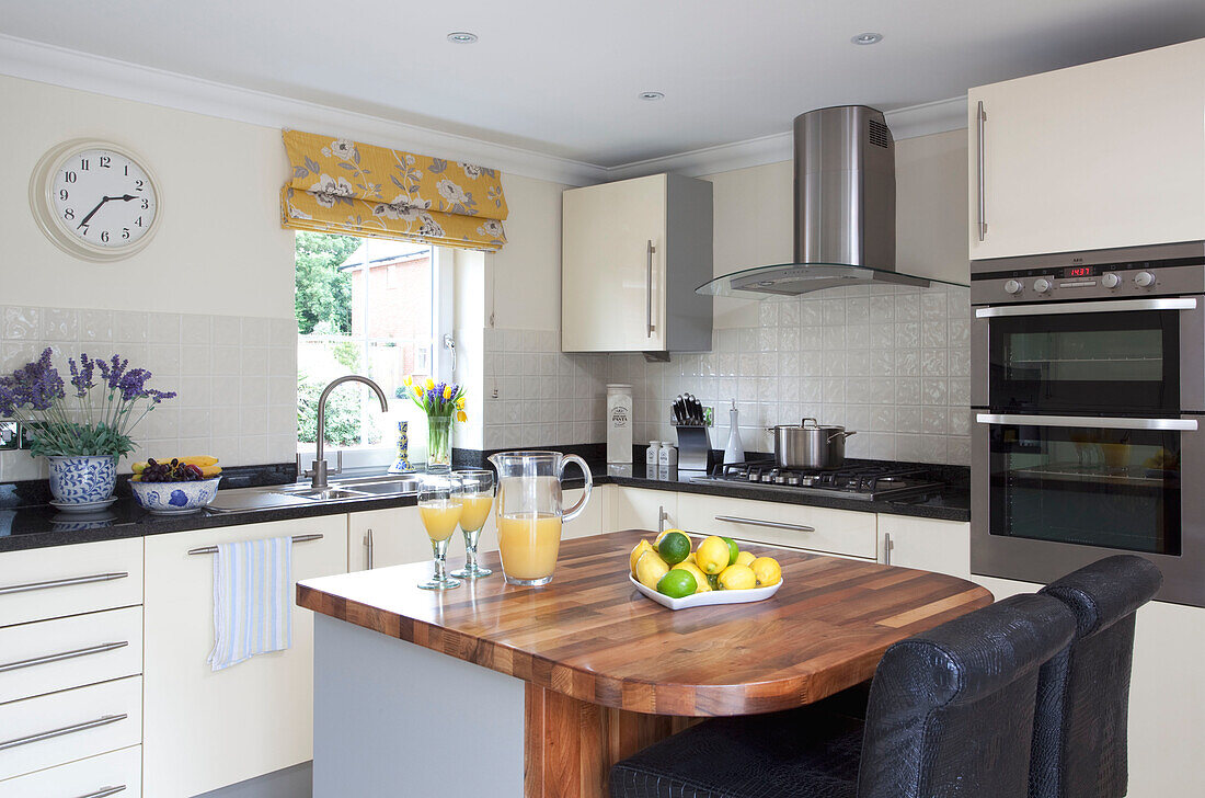 Wooden breakfast bar in contemporary Kent cottage kitchen, England, UK