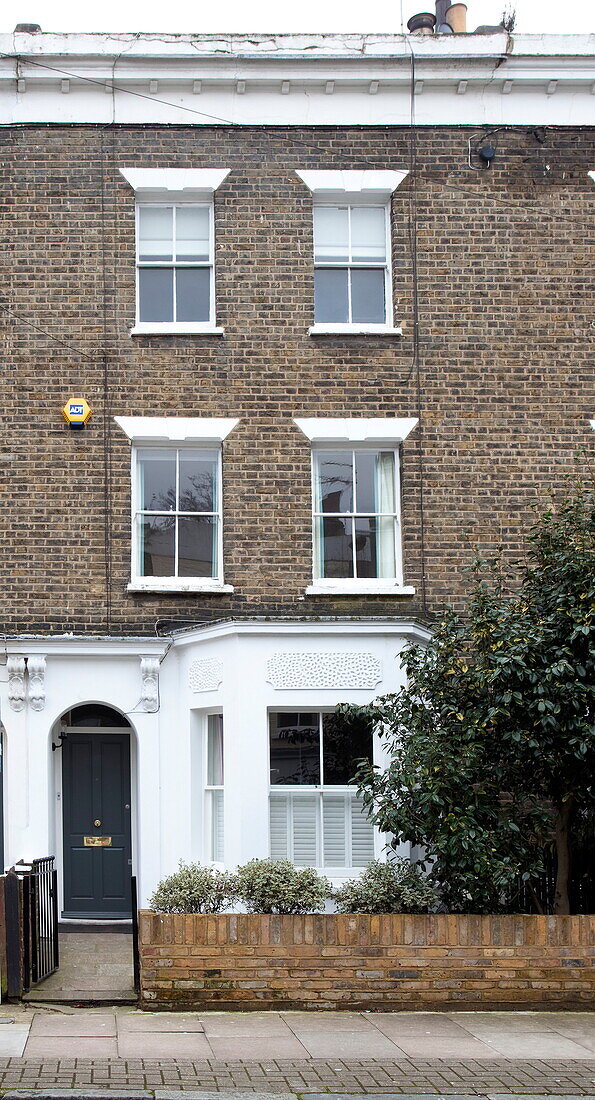 Three storey brick facade of London townhouse, England, UK