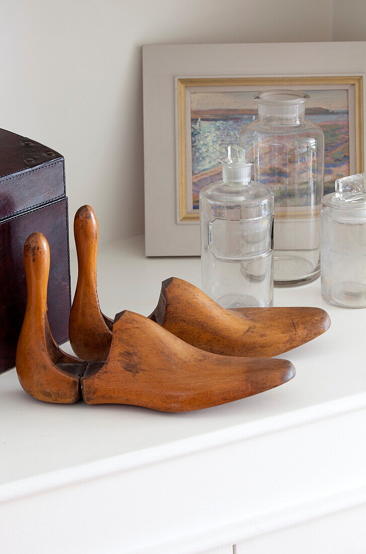 Vintage shoe stretchers with glass bottles in London townhouse, England, UK