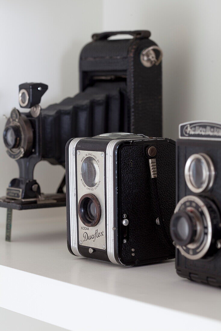 Vintage cameras on shelf in London townhouse, England, UK