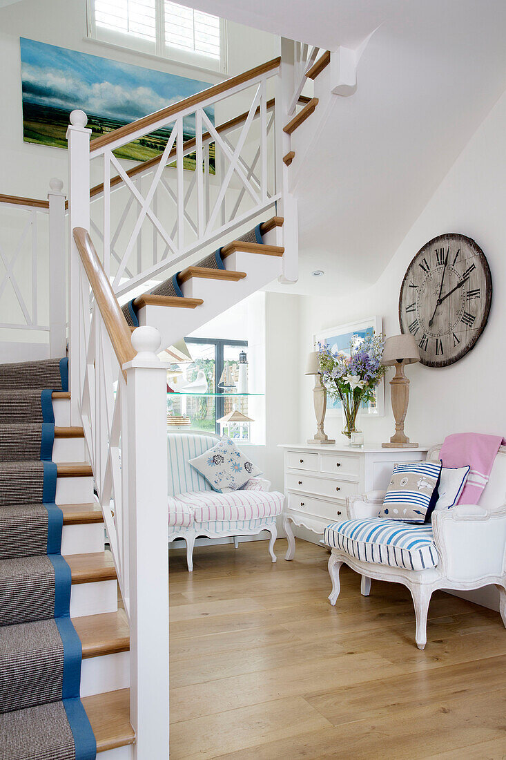 Hallway seating in open plan staircase hallway of Dulwich home, London, England, UK