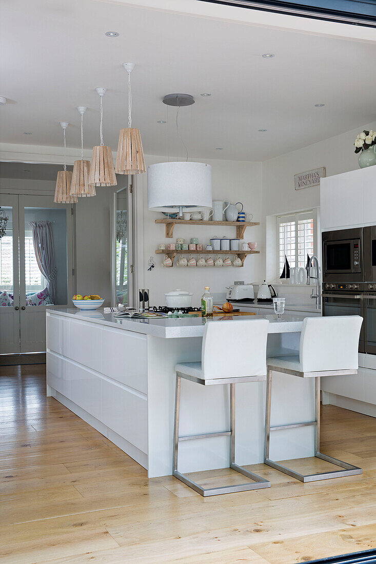 View of modern white kitchen in open plan extension in Dulwich home, London, England, UK