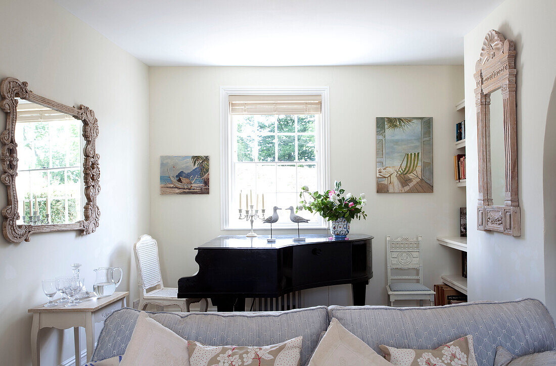 Baby grand piano at sunlit window of coastal Sussex cottage, England, UK