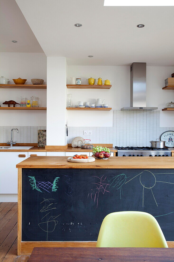 Blackboard space on side of kitchen island in Kent family home England UK