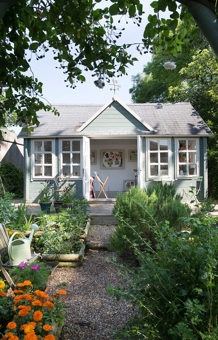 Painted summerhouse in back garden of Dorset cottage, England, UK