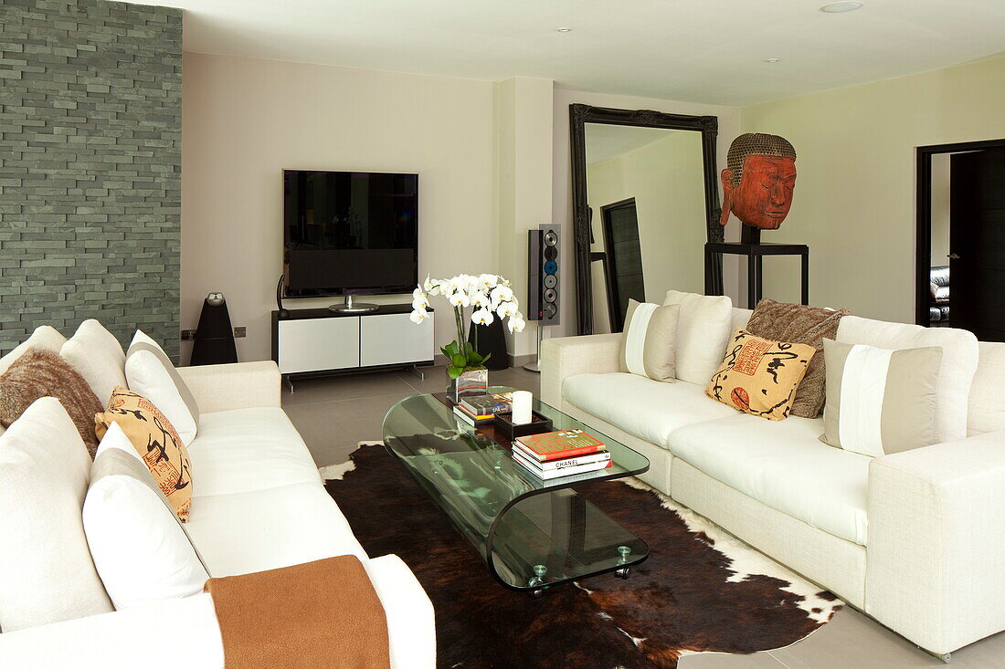 White sofas with square plasma screen television in living room of contemporary new build, Kingston upon Thames, England, UK