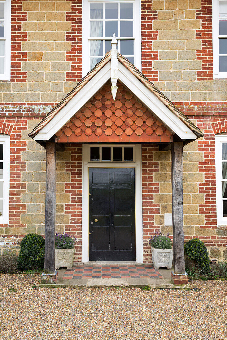 Stone and brickwork surrounding porch of London detached home England UK