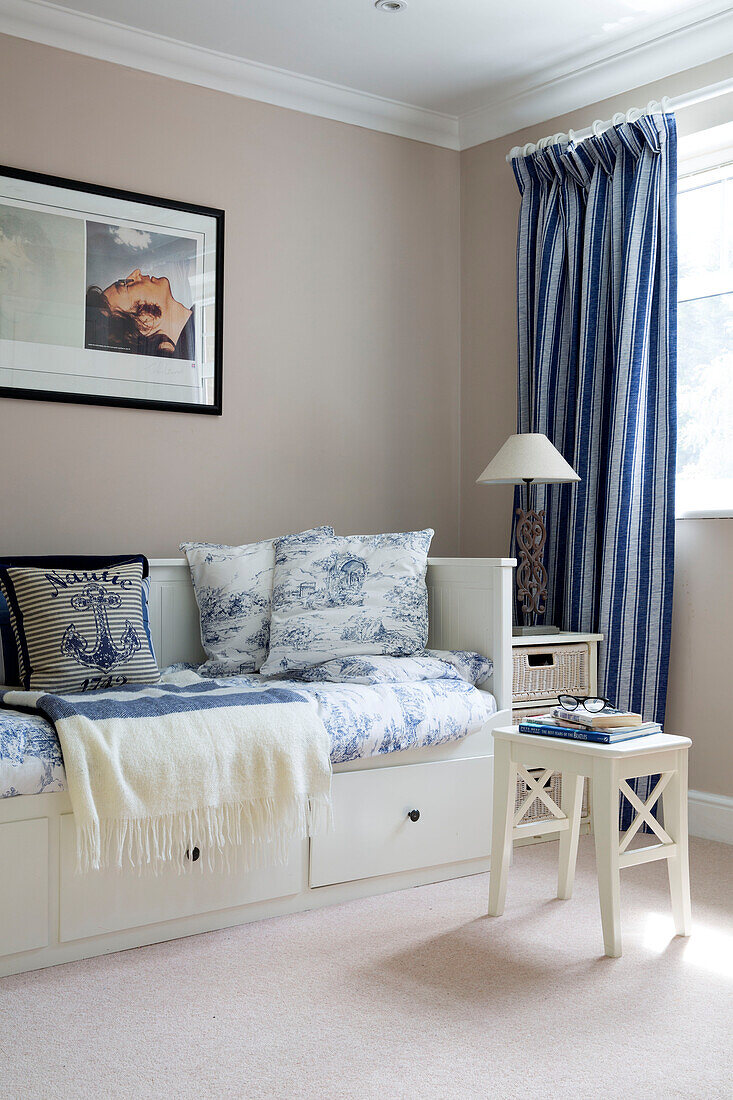 Toile de jouy cushions on daybed in London family home, England, UK