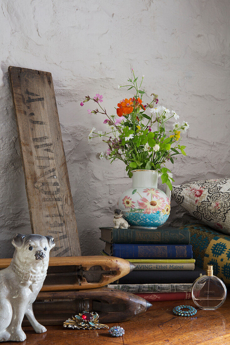 Vintage sign with cut flowers on hard backed books in Ceredigion cottage Wales UK