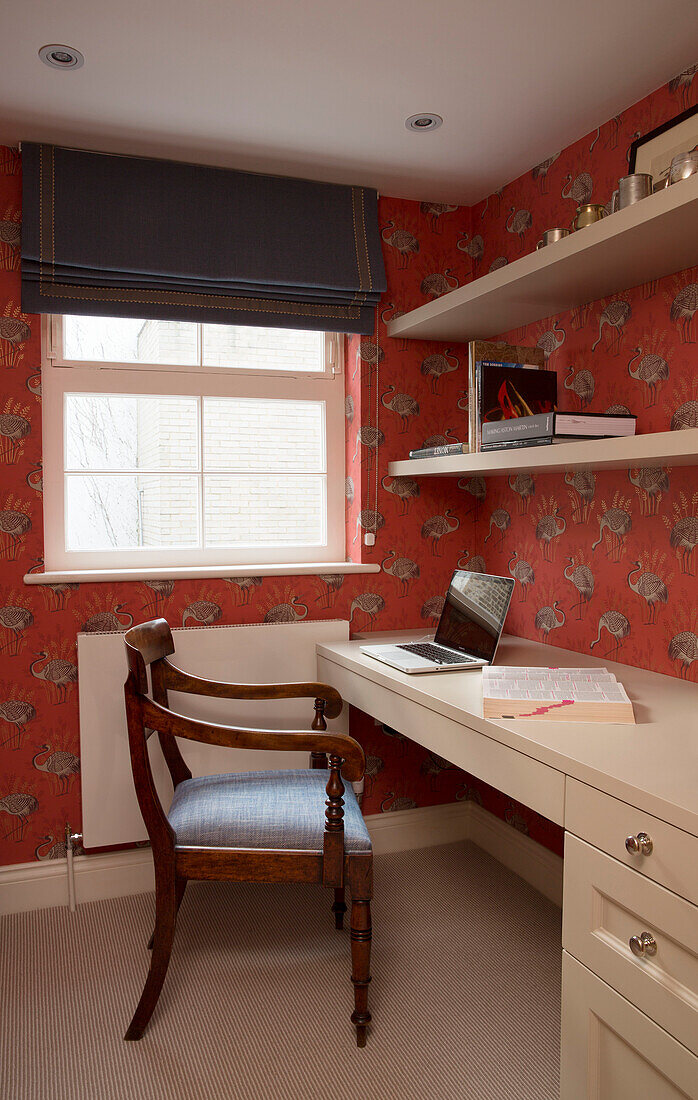 Wooden chair at cream desk with laptop in London townhouse, England, UK