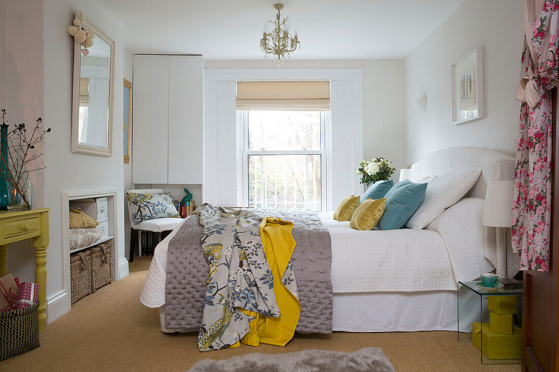 Oriental fabric on double bed in London home, England, UK