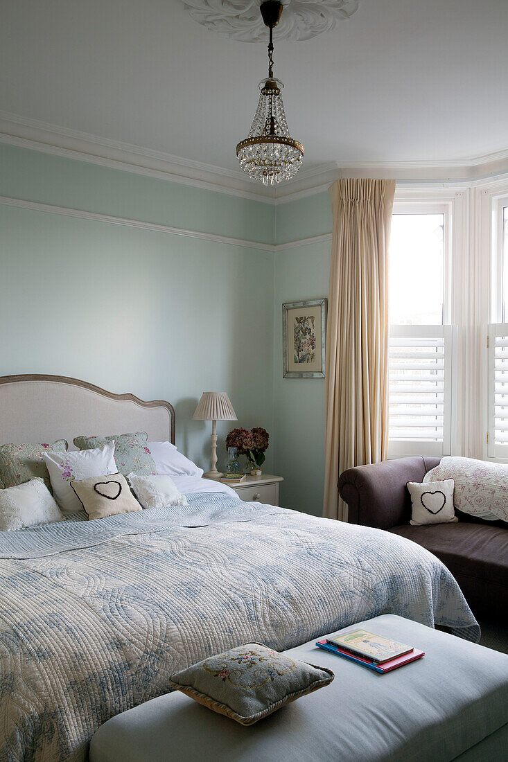 Cut glass chandelier above double bed in Shoreham by Sea home   West Susses   England   UK