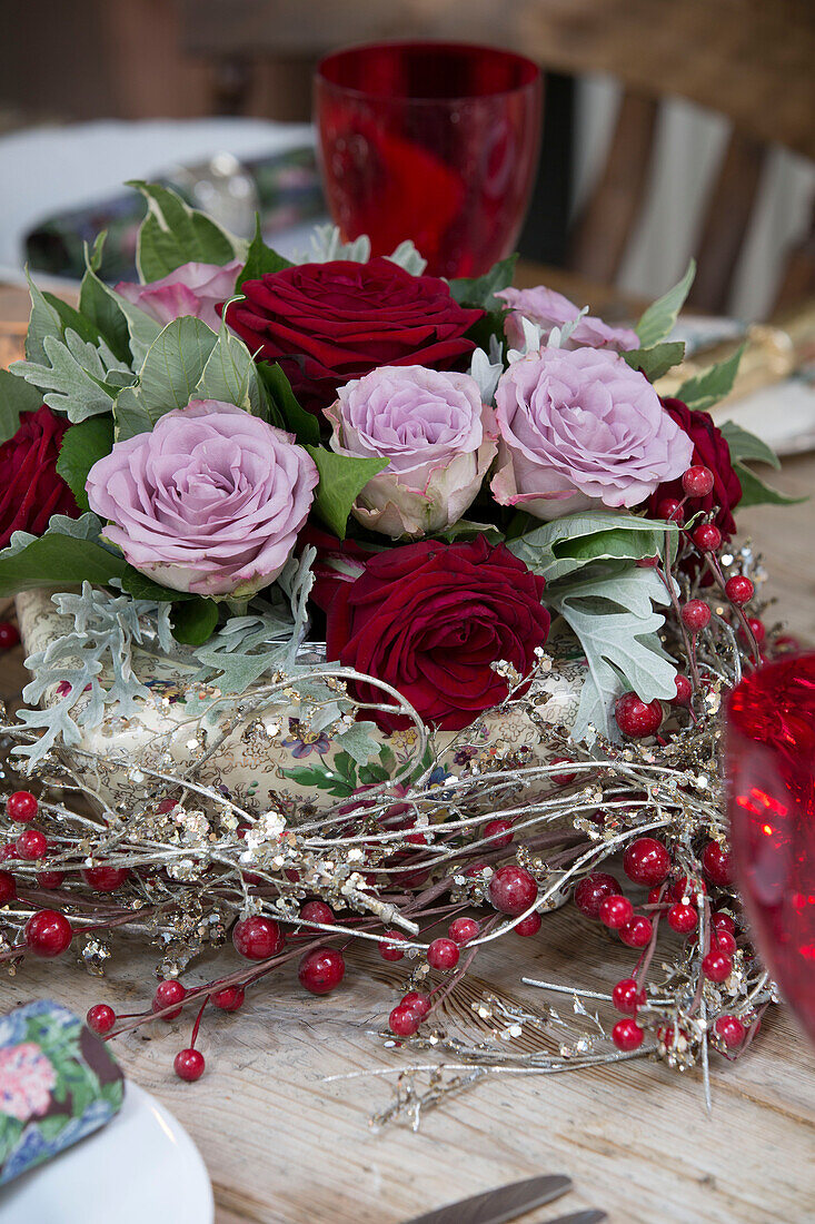 Cut roses in centrepiece on dining table in Berkshire home,  England,  UK