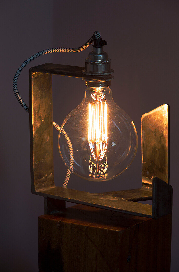 Electric light with lit filament in Sussex home UK