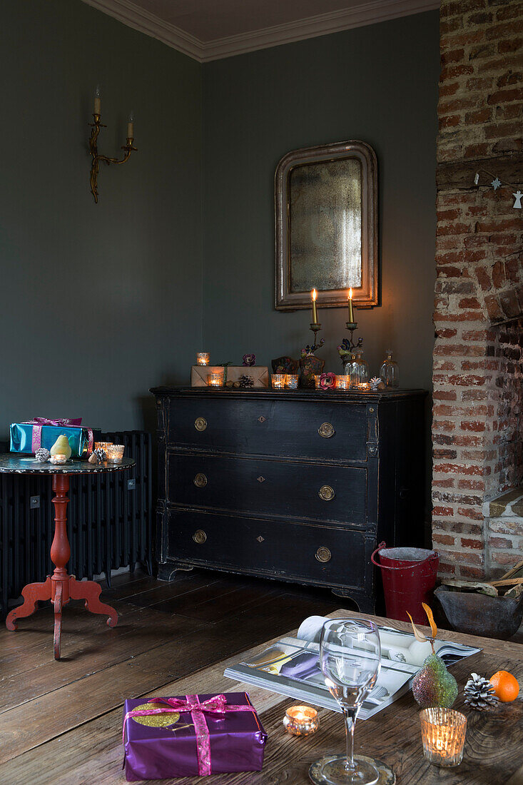 Lit candles ono black chest of drawers with vintage mirror in King's Lynn  Norfolk  England  UK