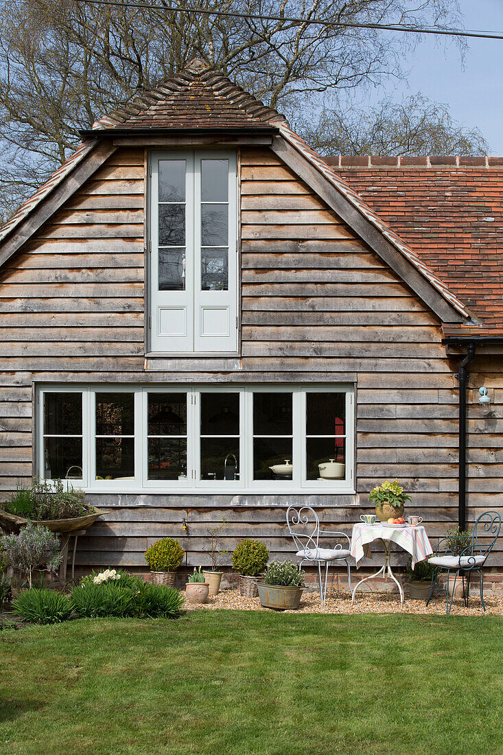 Lawned weatherboard exterior of East Dean home  West Sussex  UK