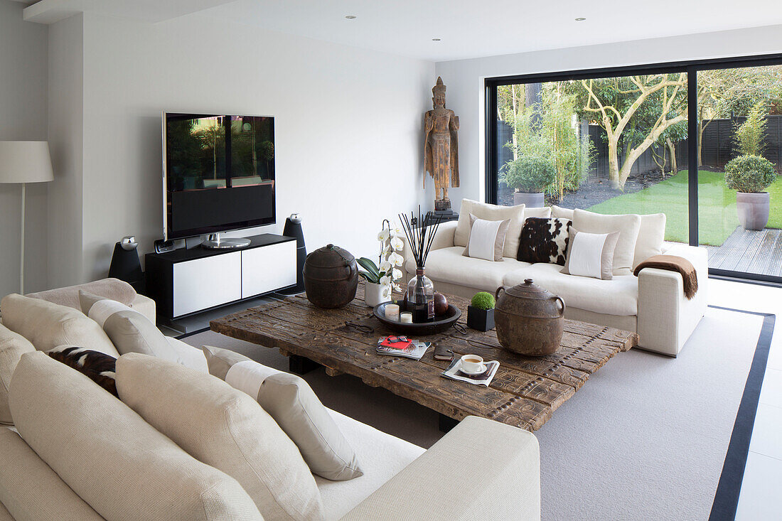 Incense and orchid on low carved table in zen styled London home,  England,  UK