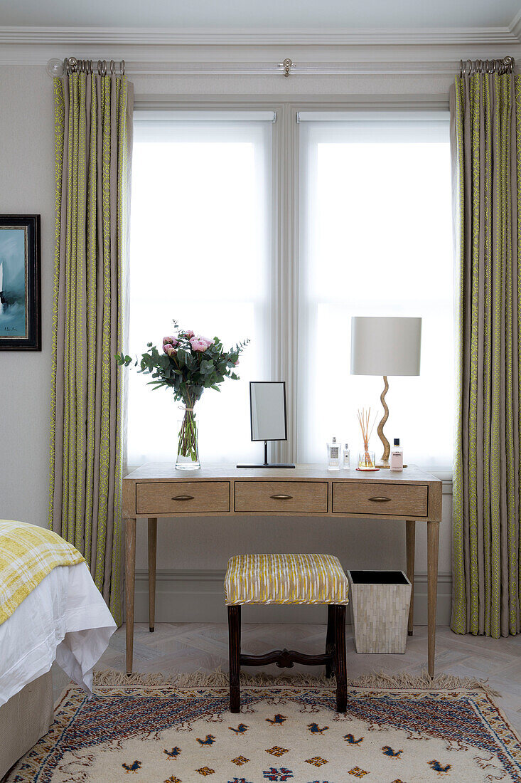 Dressing table with stool in window of London bedroom, England, UK