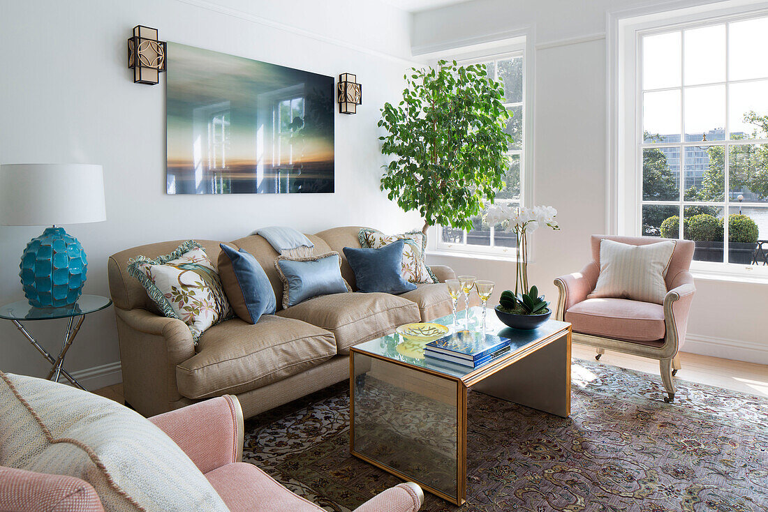 Leather sofa and artwork with Georgian windows in Grade II listed London townhouse England UK