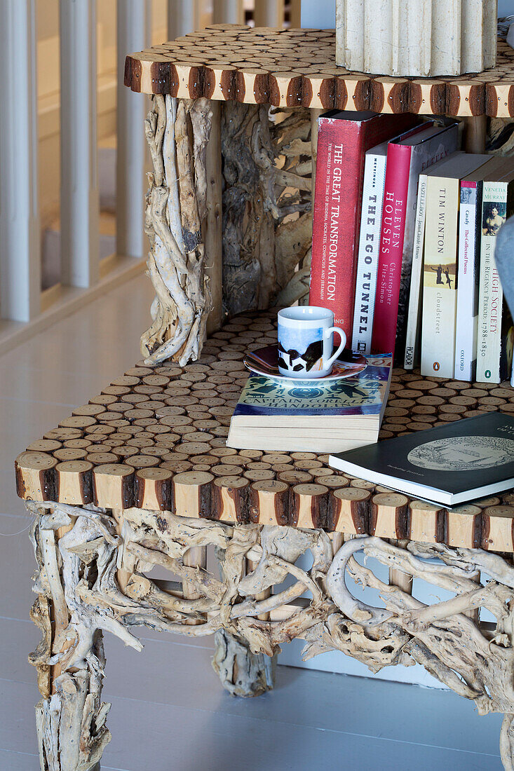 Cup and saucer with books on wooden side unit in 18th century Ithaca townhouse Greece