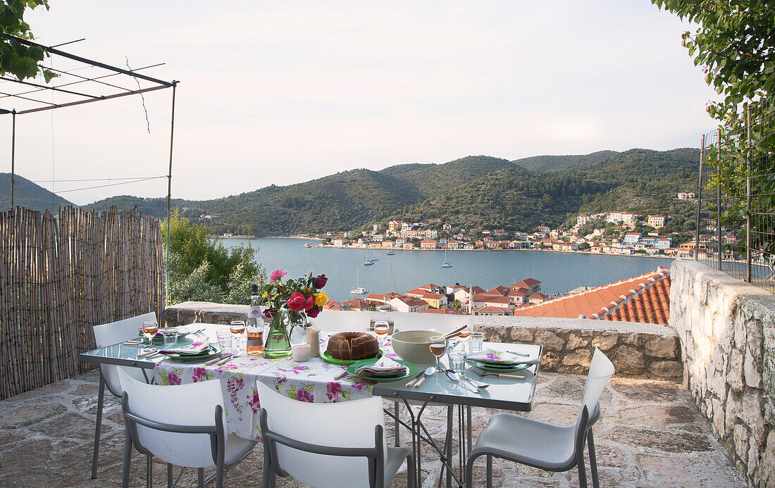 Dining table on Ithaca terrace with view of Vathy in the Aegean sea Greece