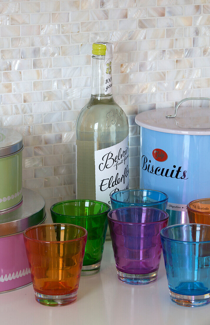 Assorted glasses with Elderflower cordial and biscuit tin in Lechlade home Gloucestershire England UK