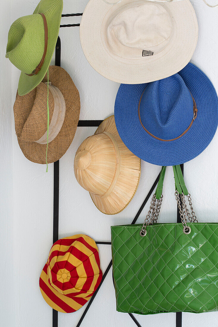 Assorted sunhats with green handbag in Var farmhouse Provence France