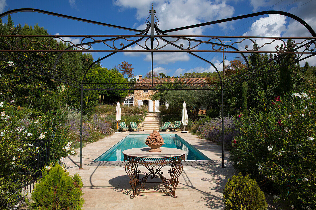 Wrought iron awning at poolside in garden of Var farmhouse Provence France