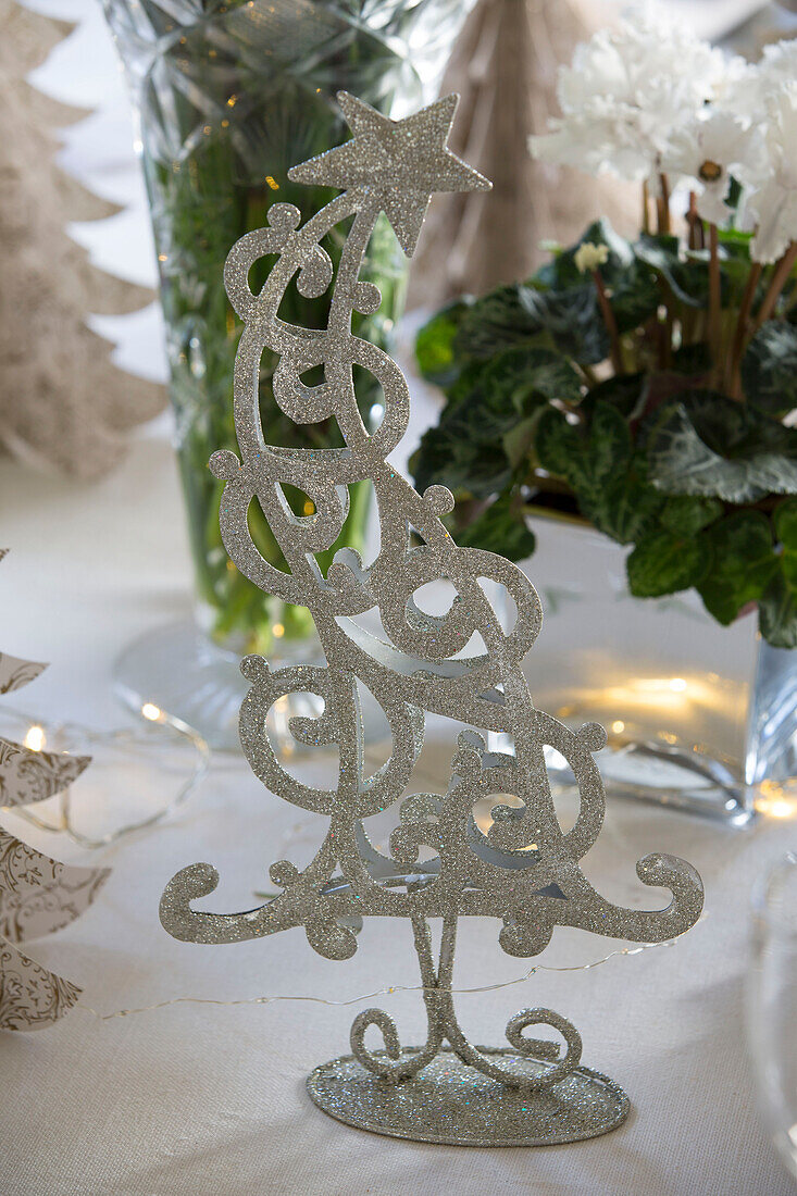 Silver Christmas tree on dining table in Sussex home England UK