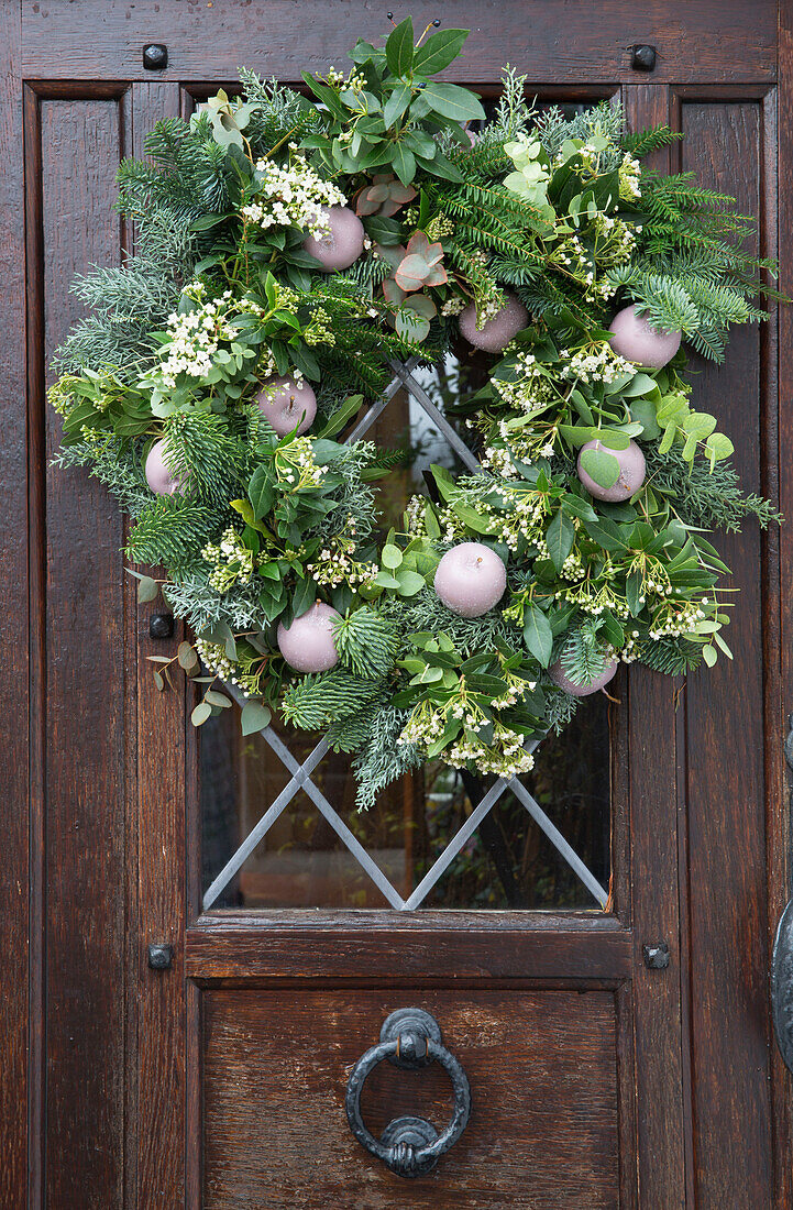 Christmas wreath on wooden front door in Kent England UK