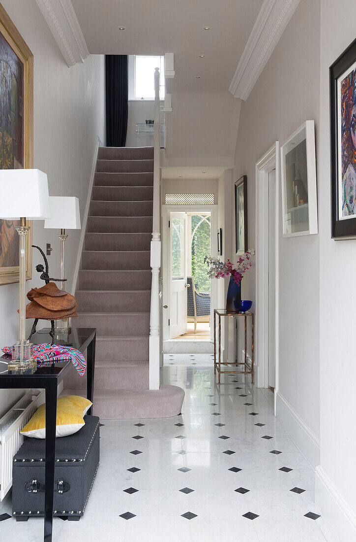 Framed artwork in tile hallway of Victorian terraced house London England UK