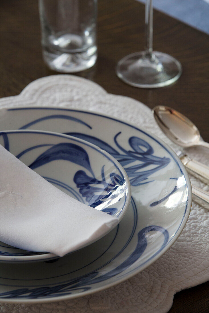 Blue and white bowl and plate on dining table in Victorian terraced house London England UK