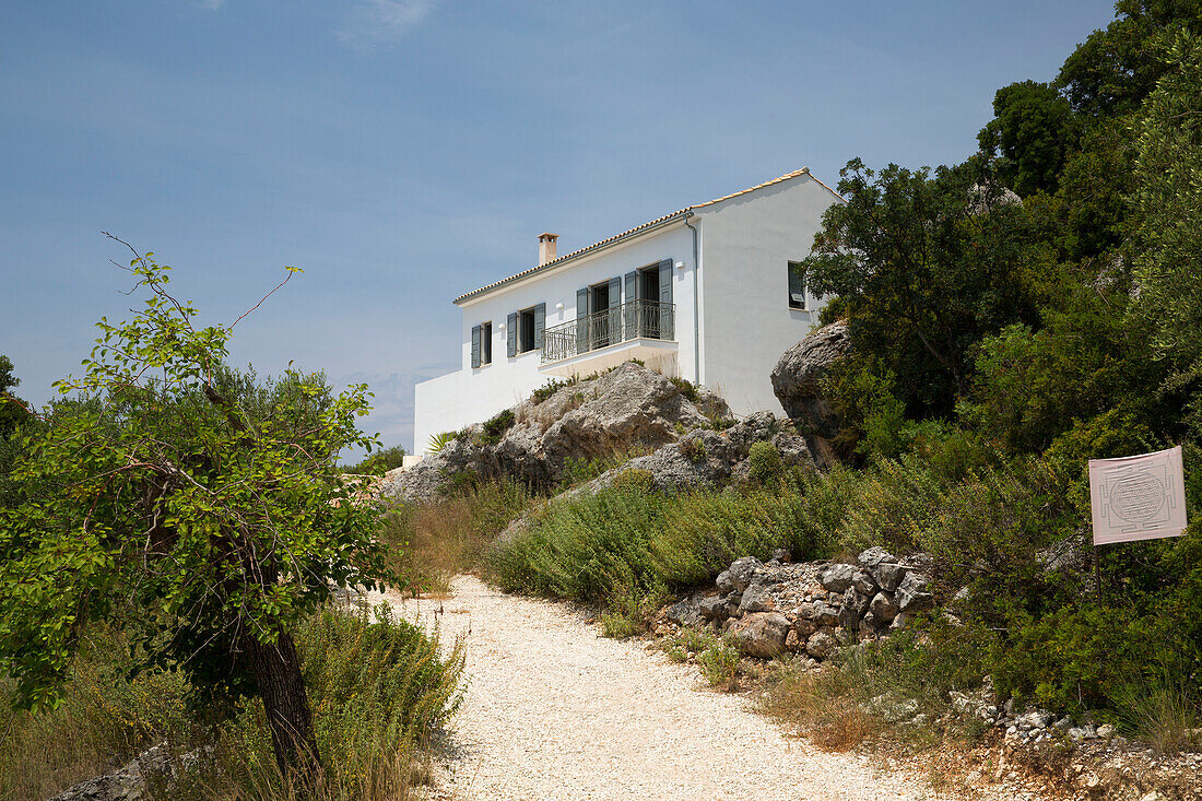 White facade of hilltop villa in Ithaca Greece