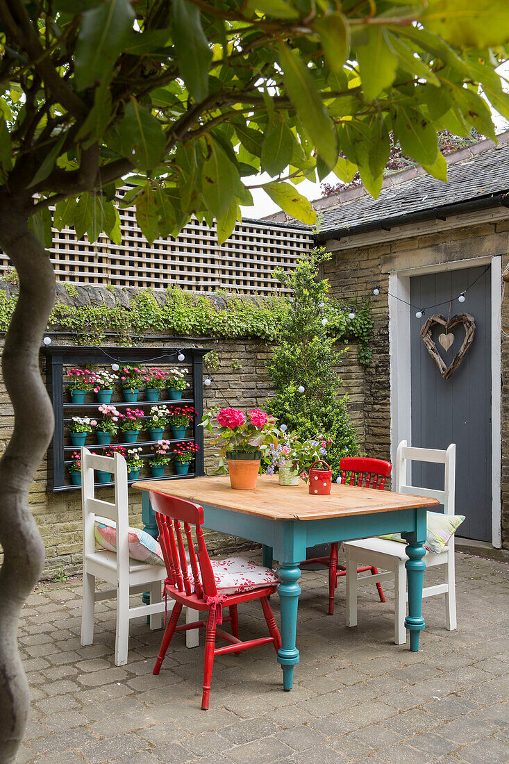 Table and chairs in walled garden of Brighouse villa West Yorkshire UK